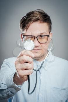 The doctor in a white lab coat holding a stethoscope