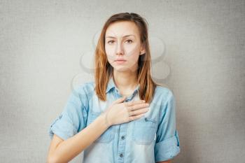 woman hand on his chest. isolated on gray background