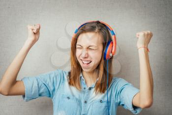 woman listening gesture muzykuv headphones. isolated on gray background