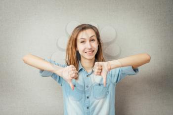 girl showing thumbs down