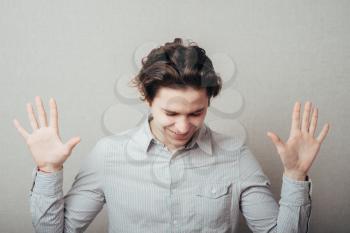 young man in despair, with hands raised up