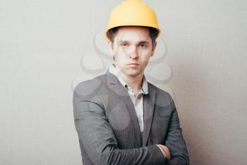 serious young man in a yellow helmet