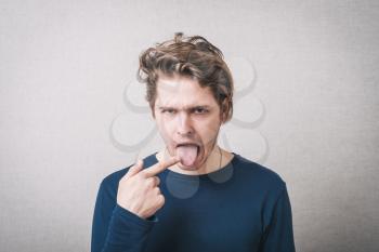 young man with finger on tongue