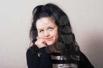 portrait of curly and beautiful woman . Gray background.