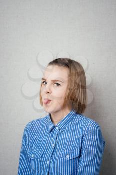 Girl sticking her tongue out, isolated