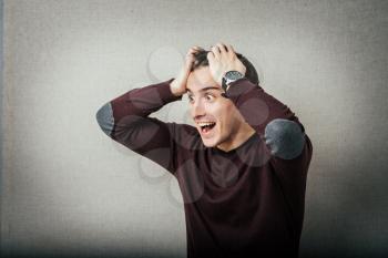 Portrait of young man with shocked facial expression