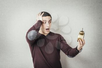 A man looking at the alarm clock. Gray background