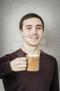 young man offers a cup of tea