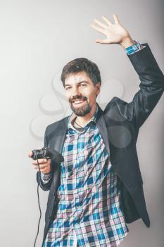 bearded businessman playing on the joystick console