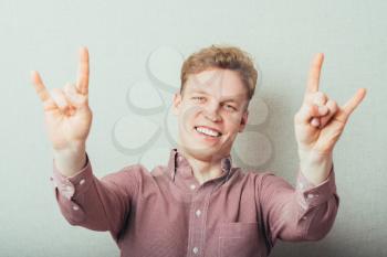 Young man rock gesture
