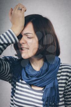 upset young woman with hand on his head