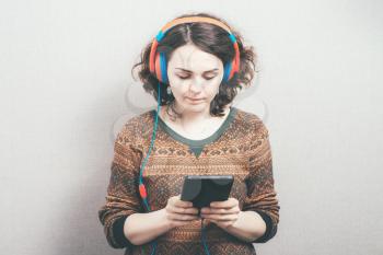 woman in headphones and a tablet