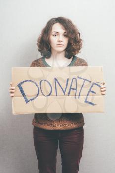girl holding a sign Donations