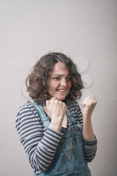 Pretty happy girl with fists