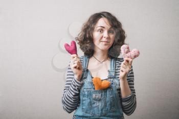 Woman with colored hearts. Gray background.