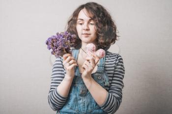 Woman with flowers and hearts. Gray background.