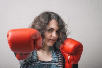 funny woman with boxing gloves, dressed in overalls