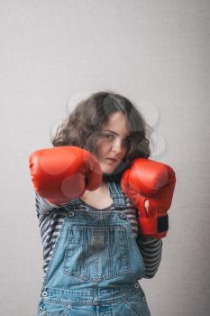 funny woman with boxing gloves, dressed in overalls