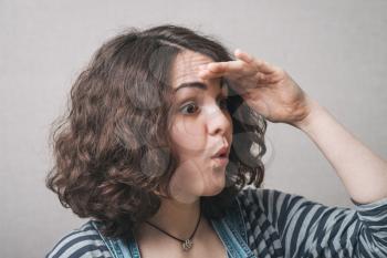 woman looking into the distance, wearing a jumpsuit