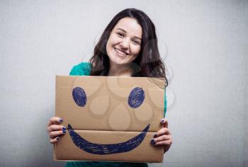 girl holding cardboard with a happy smiley