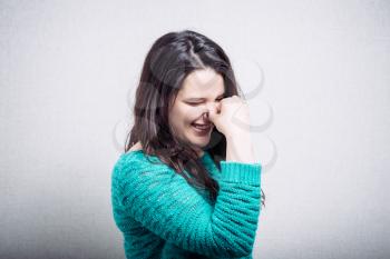 Lady covers nose with hand showing that something stinks