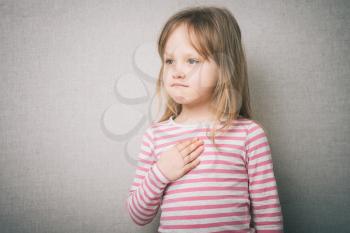 little girl,  and put her hand on  chest