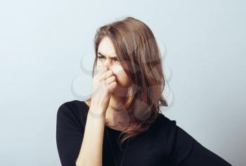 Woman closes his nose from the stench