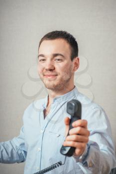 Man holding a telephone tube and smiling