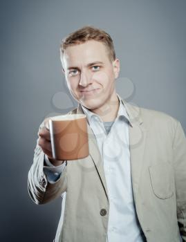 Portrait of handsome young man with cup