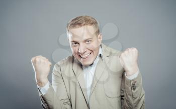 Portrait of a energetic young business man enjoying success, screaming