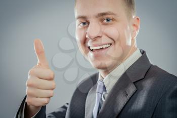 Happy businessman thumbs up sign
