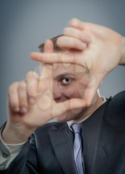 man is framing with his hands