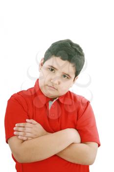 serious little boy with hands folded standing isolated on white background 
