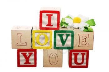 Phrase I LOVE YOU formed from wooden letter blocks 
