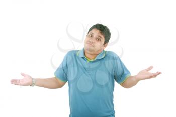 Portrait of man gesturing do not know sign against white background 
