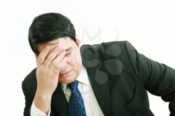 Portrait of a young business man depressed from work against white background 
