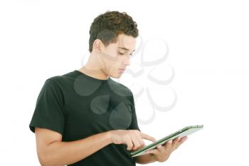 Young casual student working on a digital tablet. Isolated on a white background 
