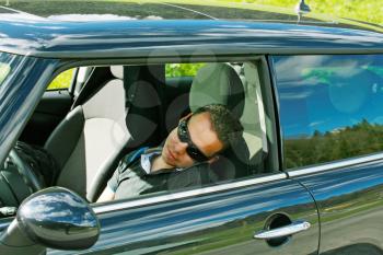 man sleeps in a car 
