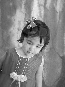 Black and white portrait of tired little girl with sad eyes. 