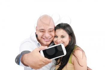 A young couple taking their picture on a mobile phone (focus on mobile phone screen) 