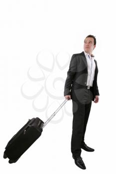 Young business man walking on white background with his trolley bag 
