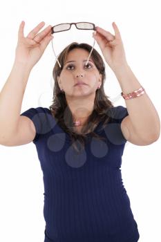 hispanic young woman checking her eyeglasses