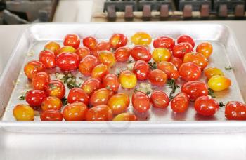 Many colorful Tomato red and yellow on a tray ready to be served with a steak