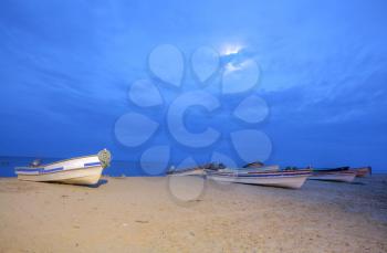 Boats on the beach starting the sunset