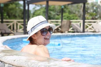 Beautiful woman smiling in the pool
