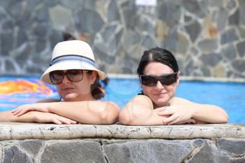 Two sexy women in the pool. Focus in the right lady.