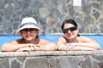 Happy friends in the pool. Focus in the right lady.