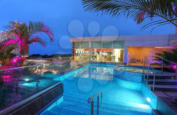 Fitness area with outdoor swimming pool in the sunset