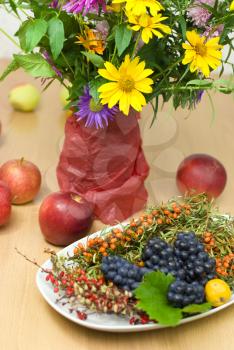 Royalty Free Photo of a Plate of Fruit and Flowers