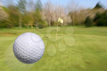 Golf ball flying to the cup. Zooming to the hole.